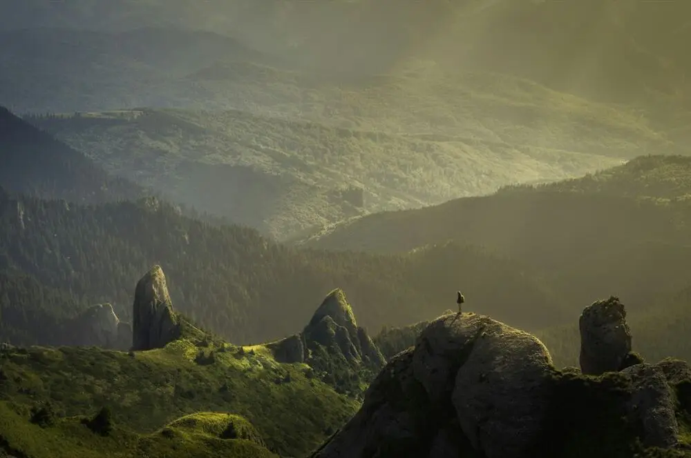 Traveler looking out over a mountain landscape