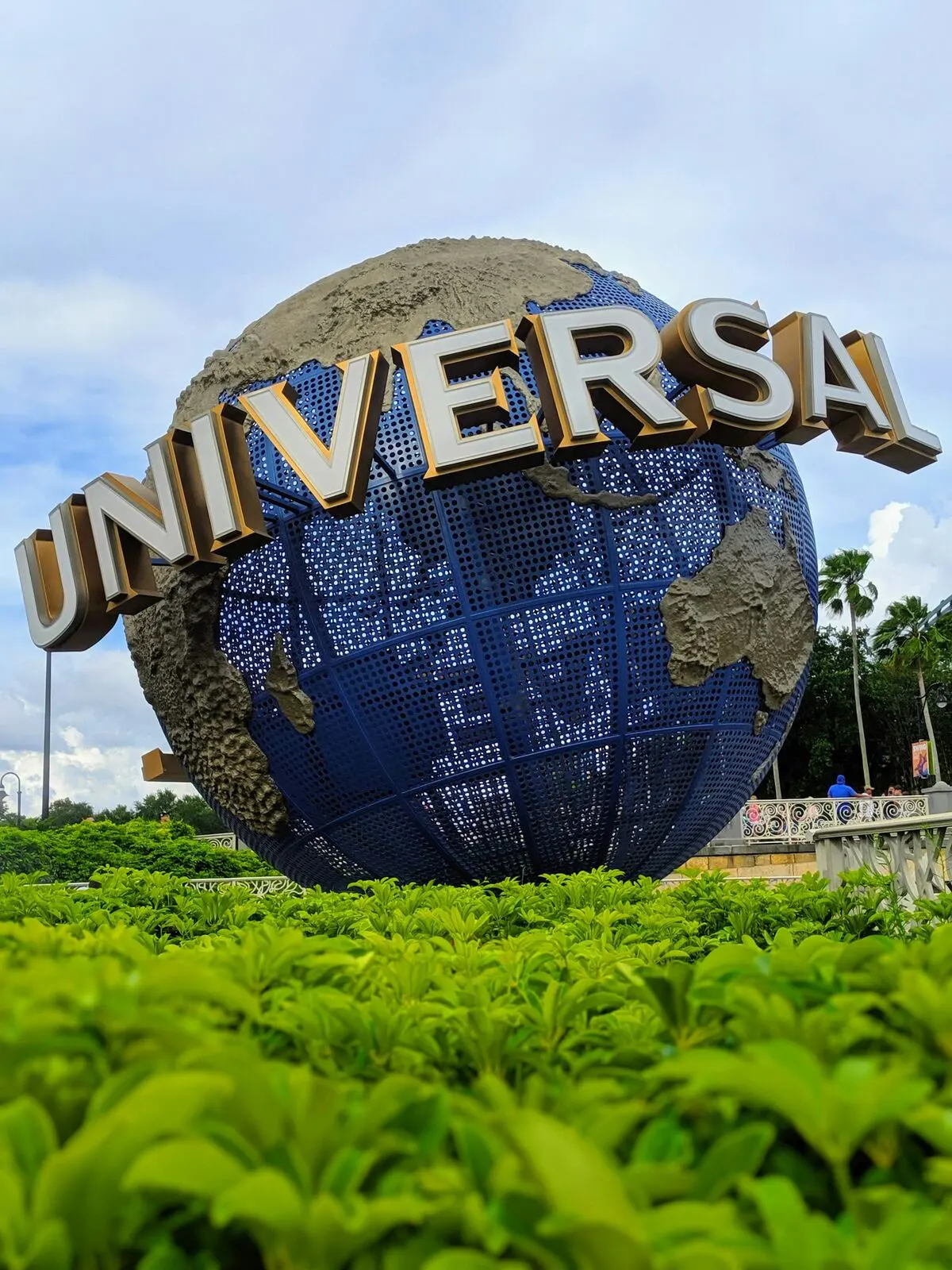 Universal Studios globe among palm trees